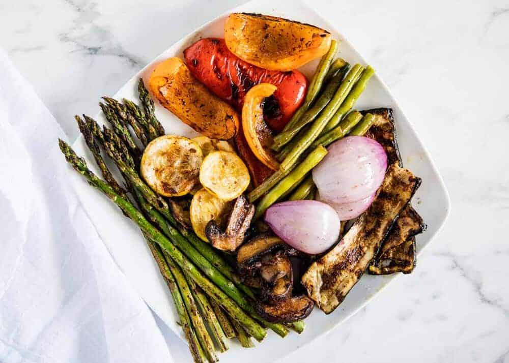 Grilled vegetables on a white plate.