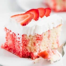 jello poke cake with whipped cream and strawberries