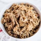 shredded kalua pork in a white bowl