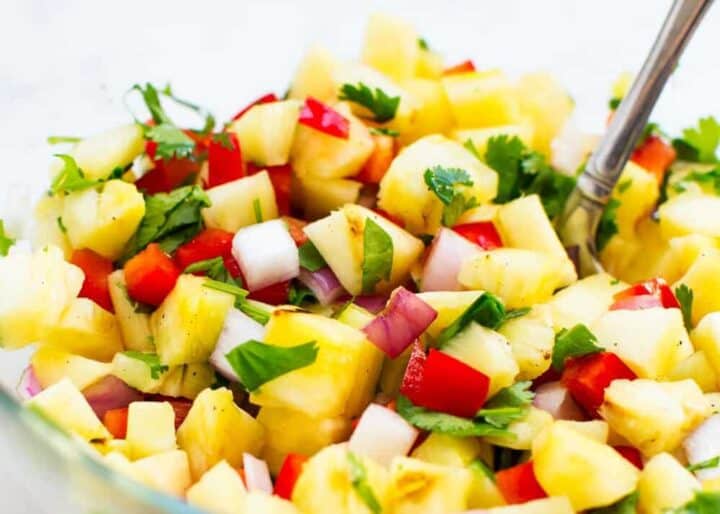 pineapple salsa in a bowl with a spoon