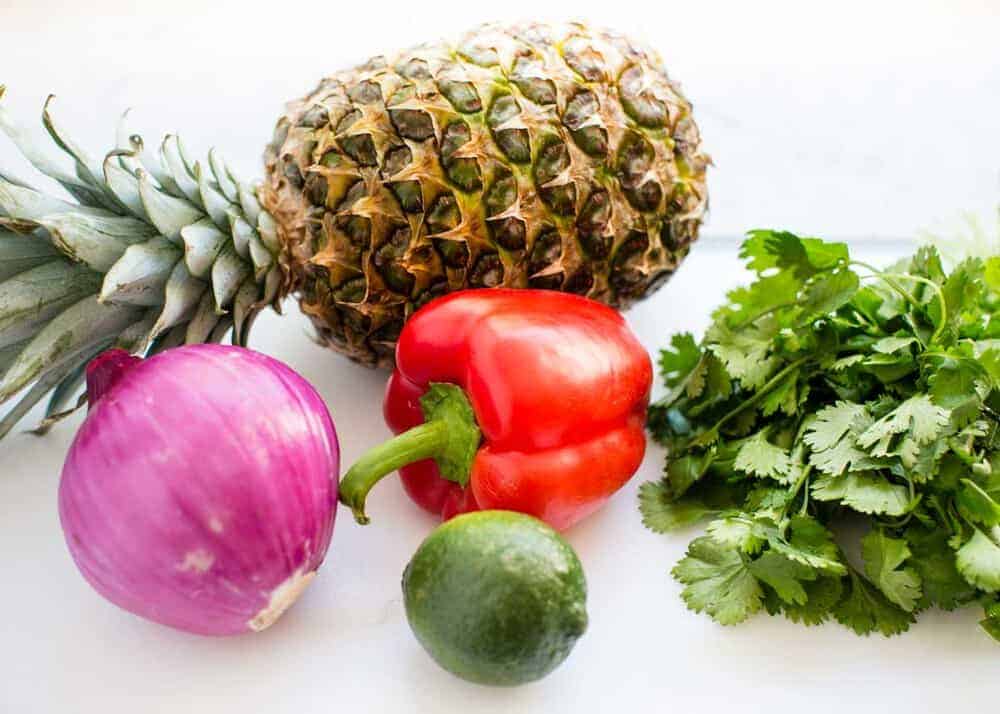 Pineapple salsa ingredients on cutting board.