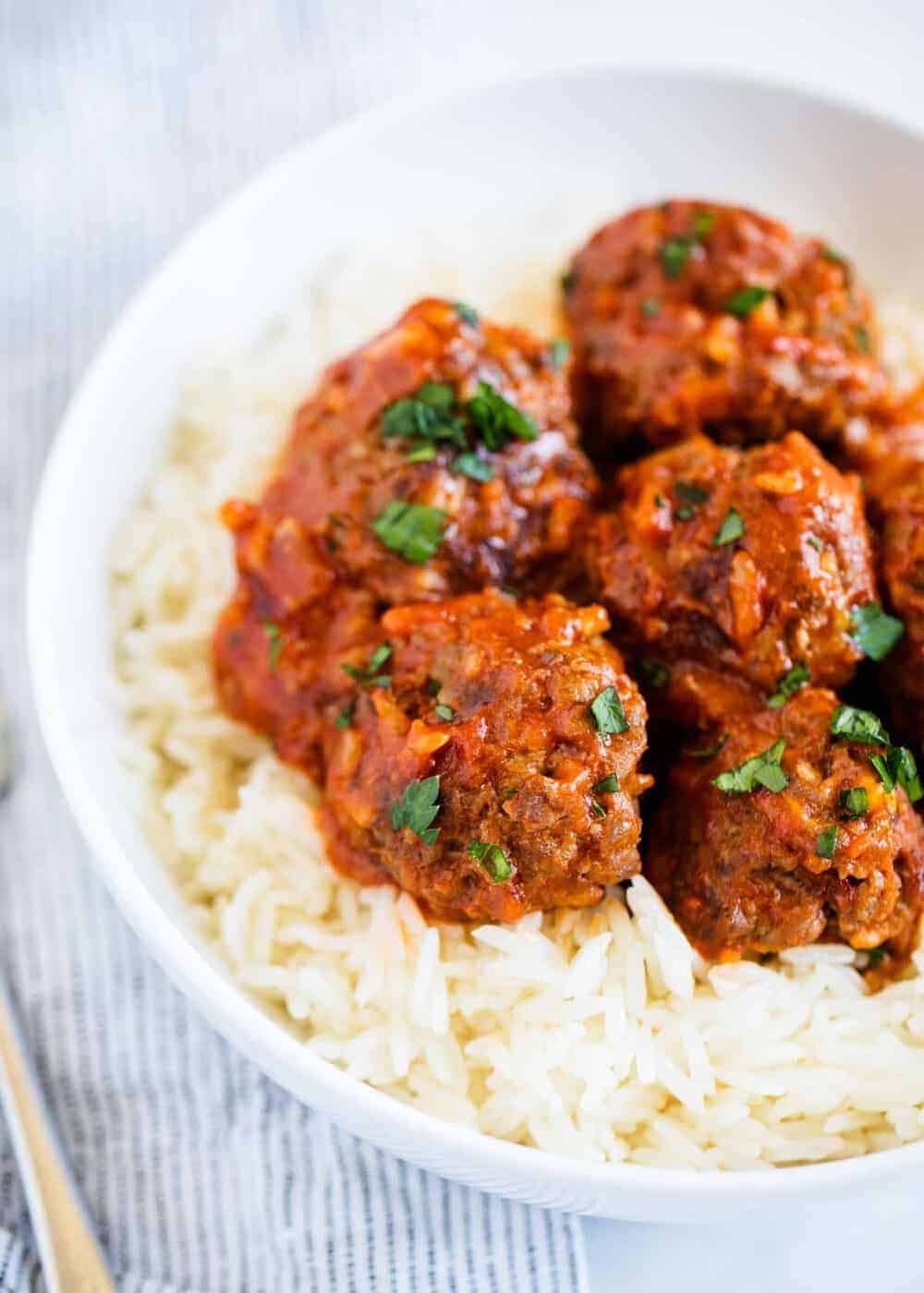 porcupine meatballs served over rice with tomato sauce and parsley
