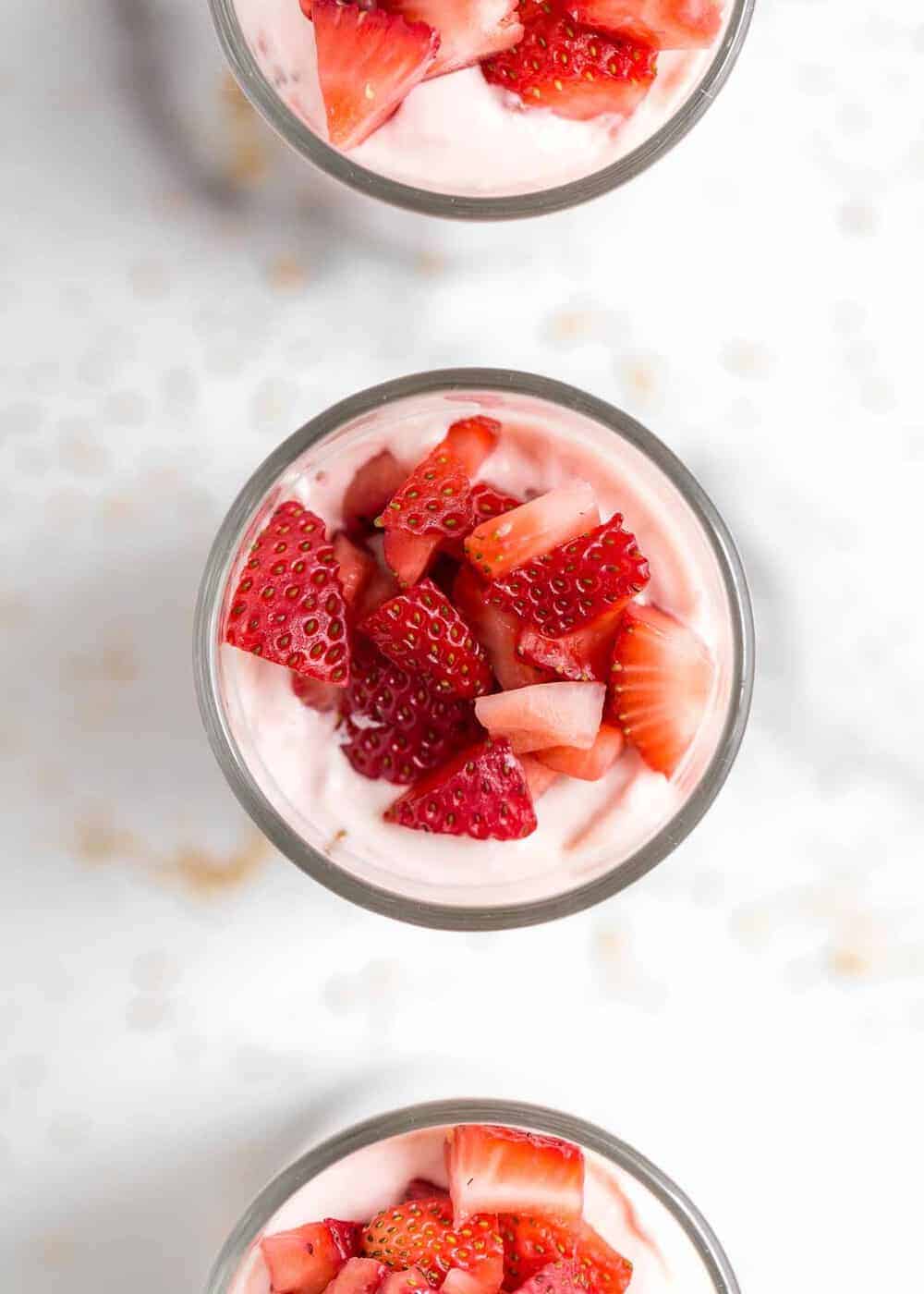 Strawberry mousse cheesecake with diced strawberries on top.