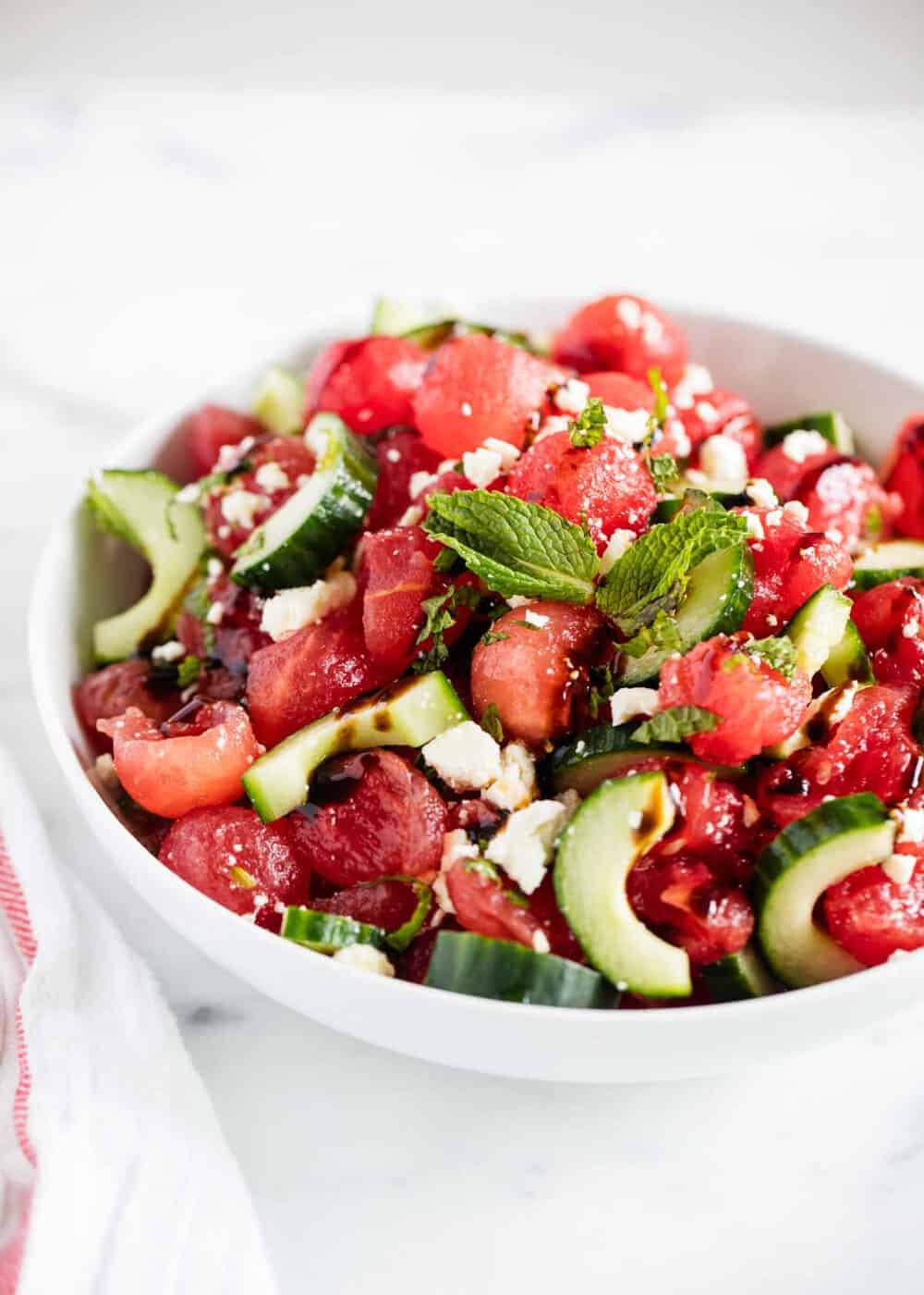 Bowl of watermelon salad drizzled with balsamic.