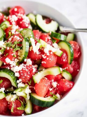 watermelon salad with cucumber in white bowl