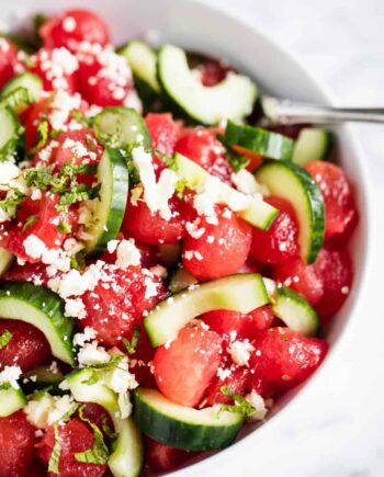 watermelon salad with cucumber in white bowl