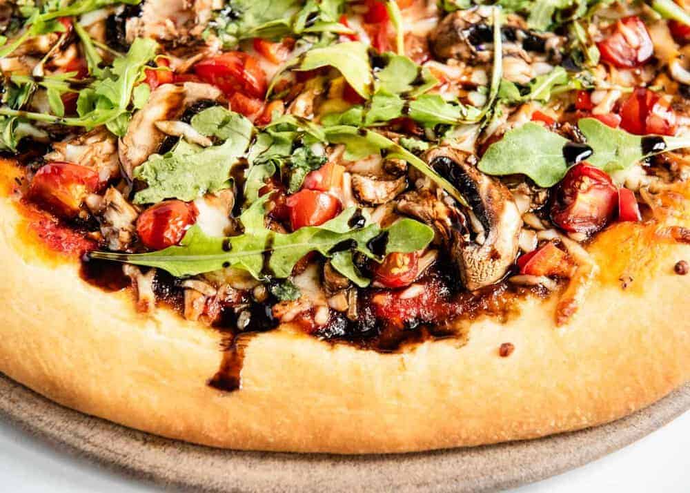 Whole wheat pizza with tomatoes, arugula and balsamic.