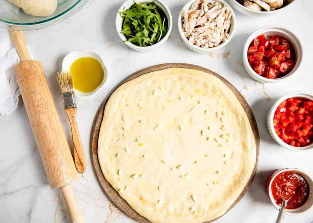 Whole wheat pizza dough rolled out.