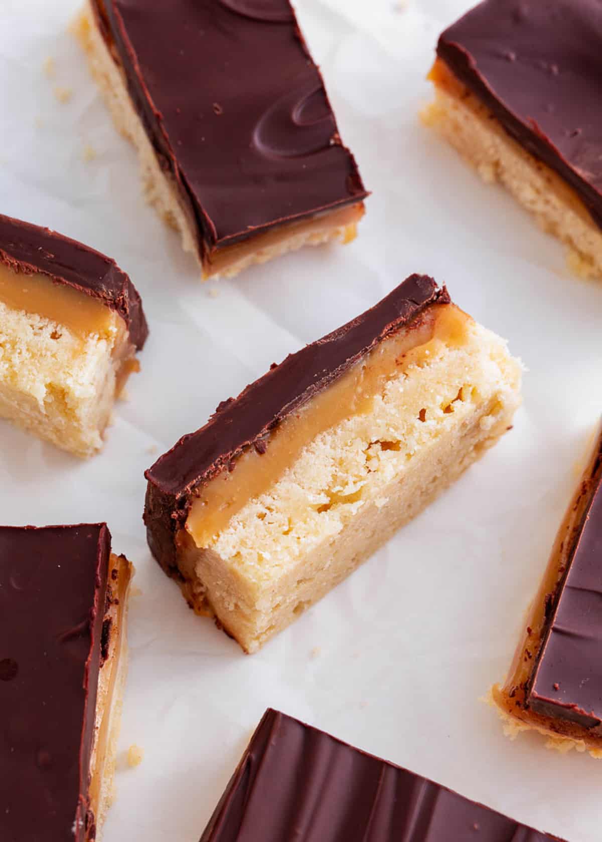 Twix bars on a piece of parchment paper.