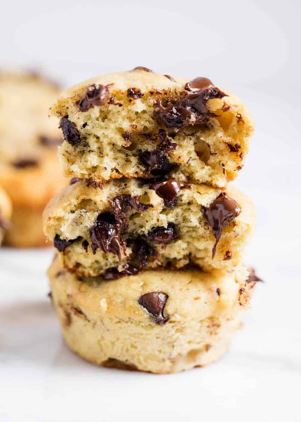 Stack of chocolate chip banana bread muffins with bite taken out.