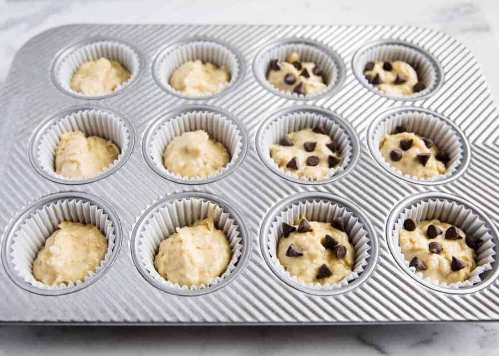 Muffin tin filled with banana bread muffin batter.