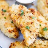 crispy chicken tenders with parsley on top