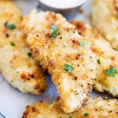 crispy chicken tenders with parsley on top