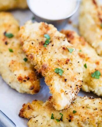 crispy chicken tenders with parsley on top