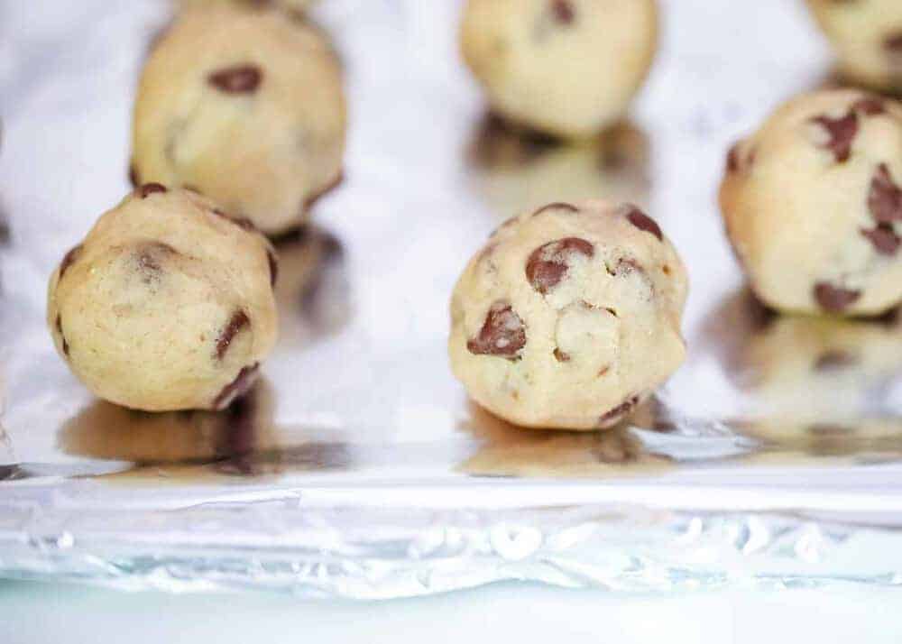 Cookie dough balls on a baking sheet.