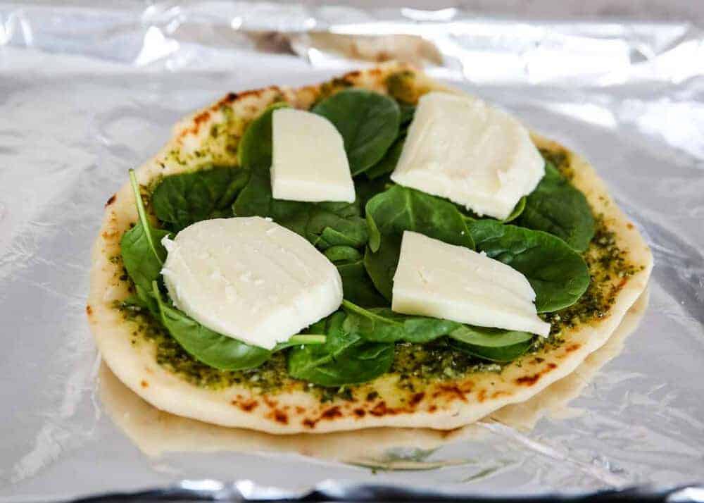 Naan bread with fresh mozzarella, pesto and spinach.