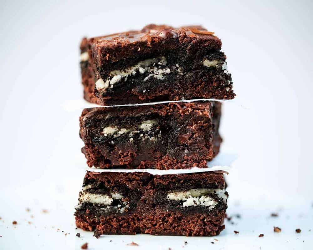 These Oreo brownies are rich, chewy and a chocolate lover's dream! Delicious layers of fudgy brownie mix and Oreo cookies baked to perfection. Stack of Oreo brownies.