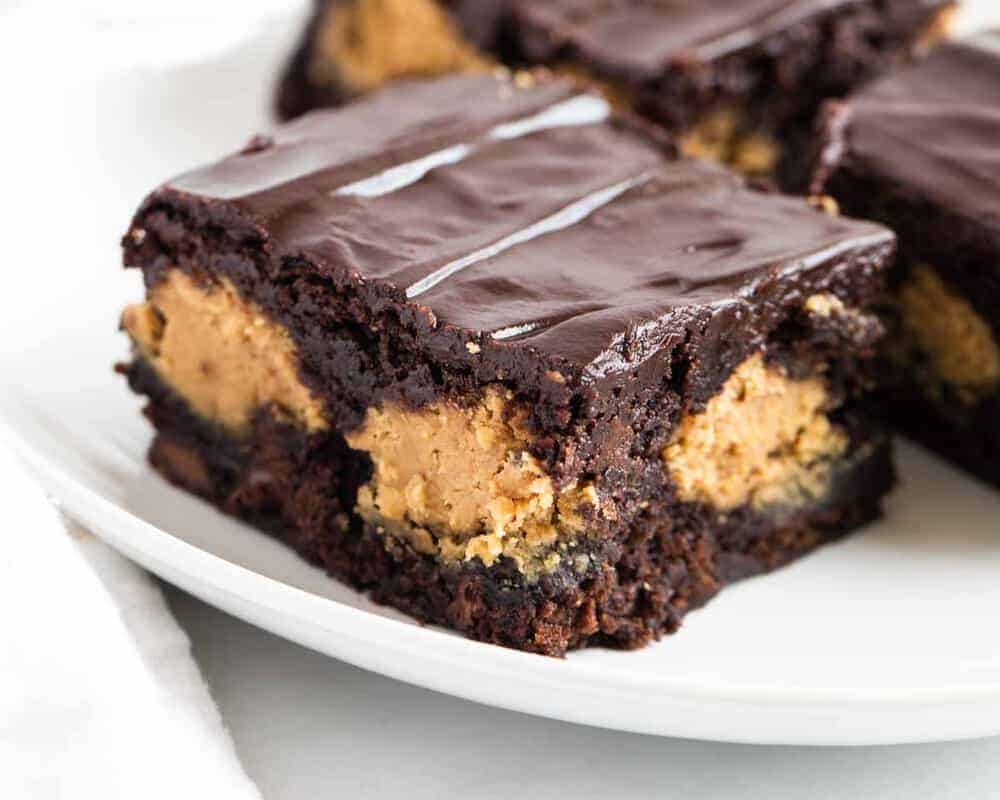Peanut butter brownies on a white plate.