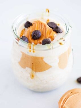 Peanut butter overnight oats in a jar with chocolate chips on top.