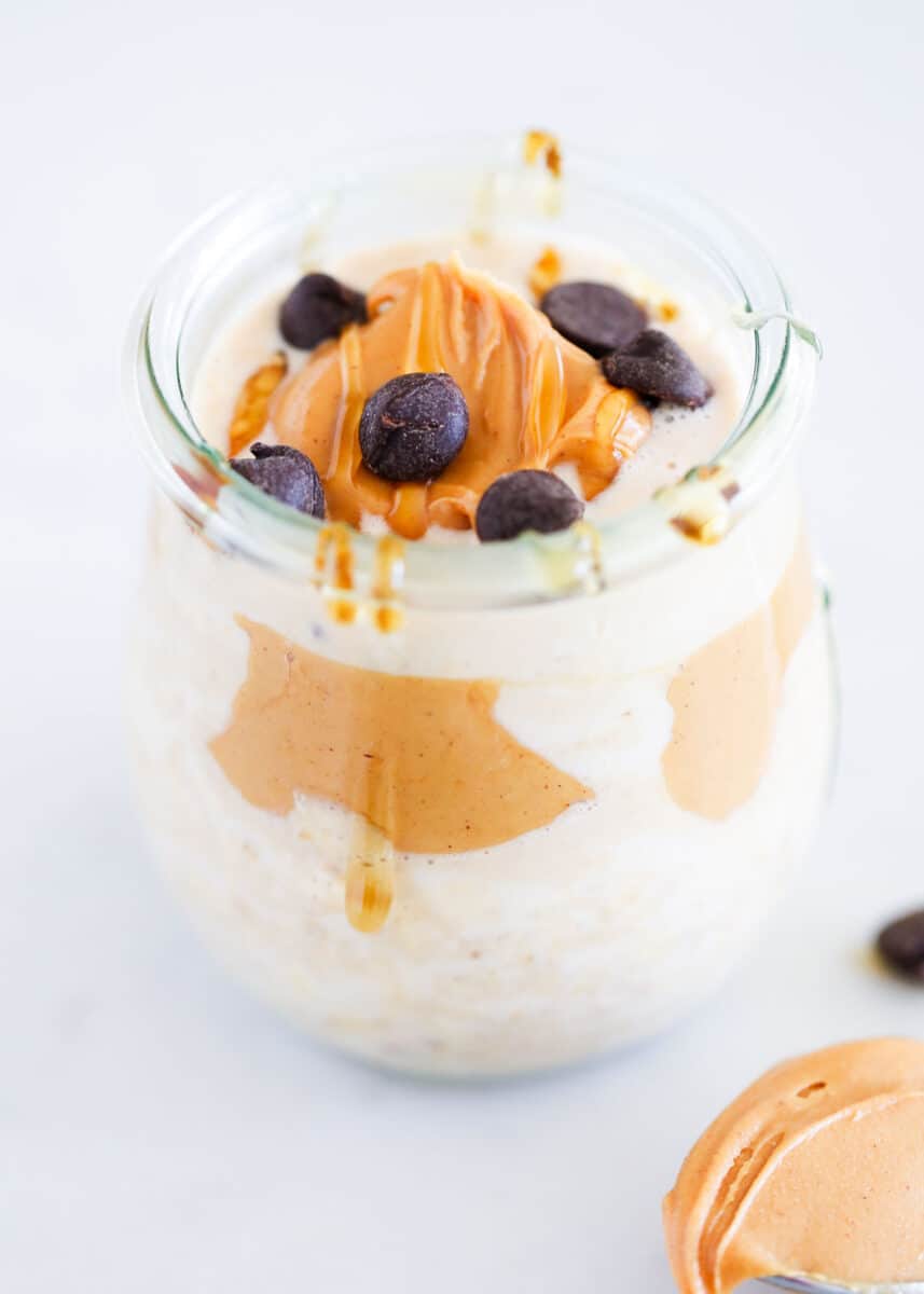 Peanut butter overnight oats in a jar with chocolate chips on top.