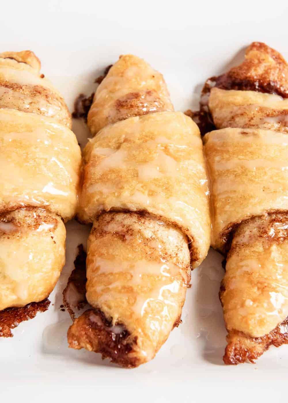 Cinnamon sugar crescent rolls with glaze on top.