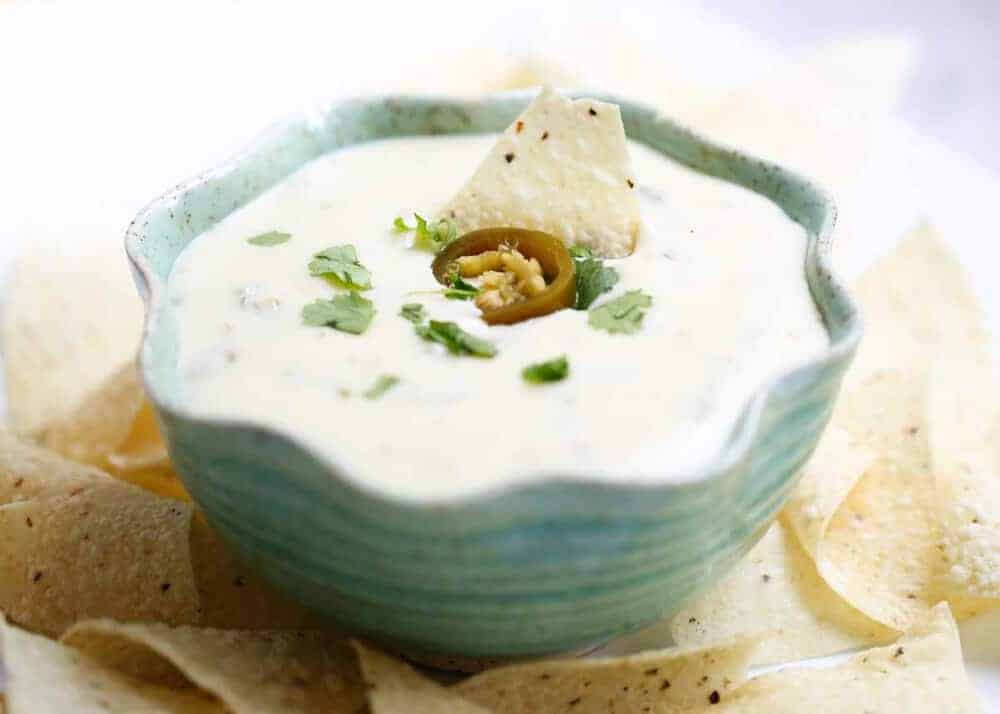 Bowl of queso Blanco served with tortilla chips.