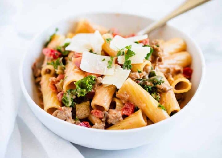 rigatoni noodles with bolognese sauce in white bowl