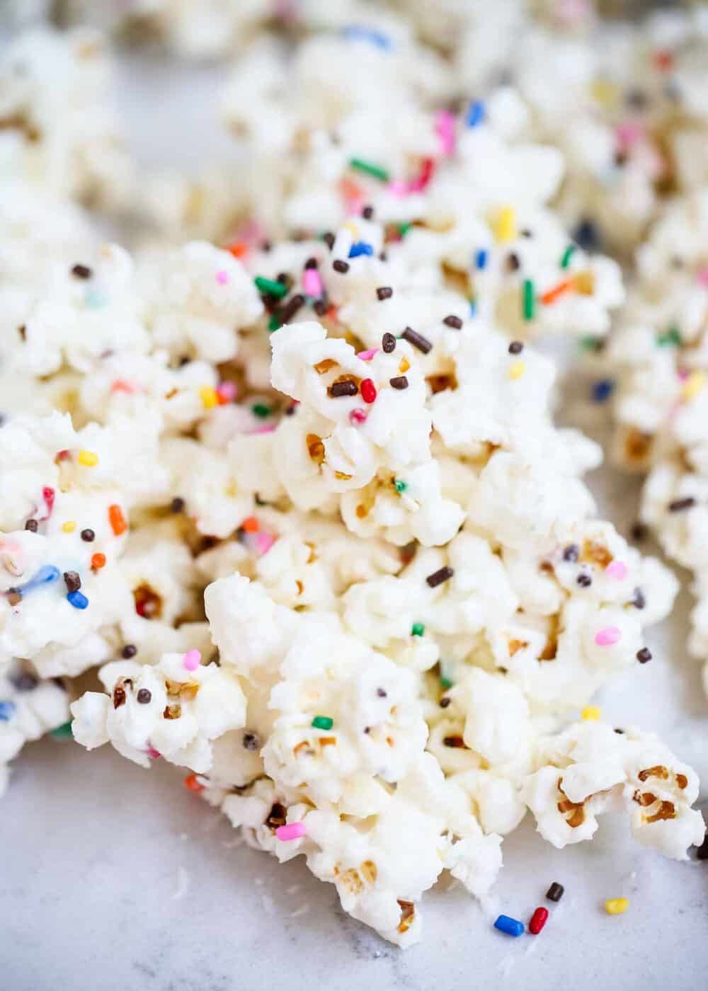 A close up of cake batter popcorn with sprinkles.