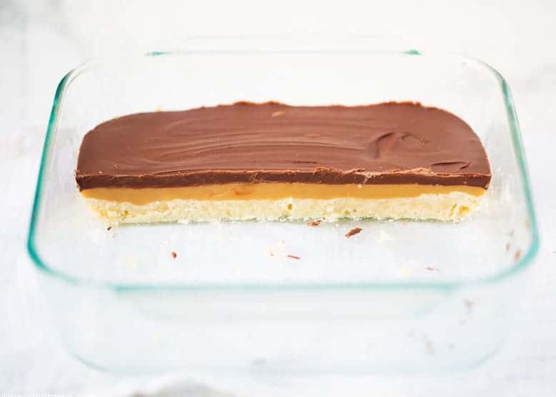 sliced twix cookie bars in a baking dish 