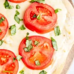 white pizza with fresh tomatoes and basil