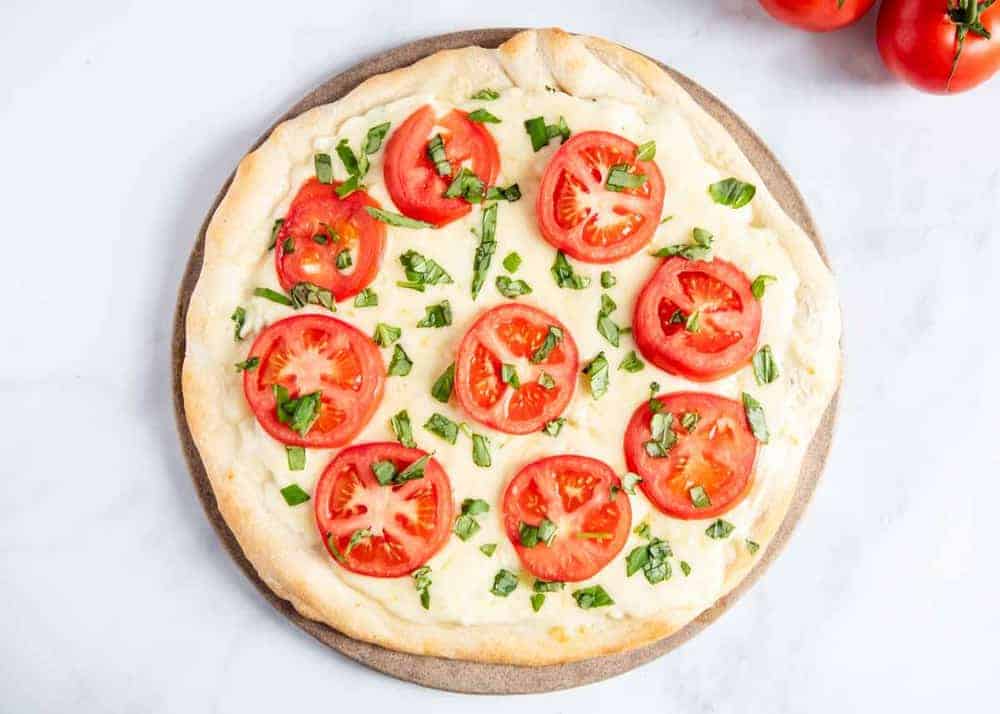 White pizza with tomatoes and basil.