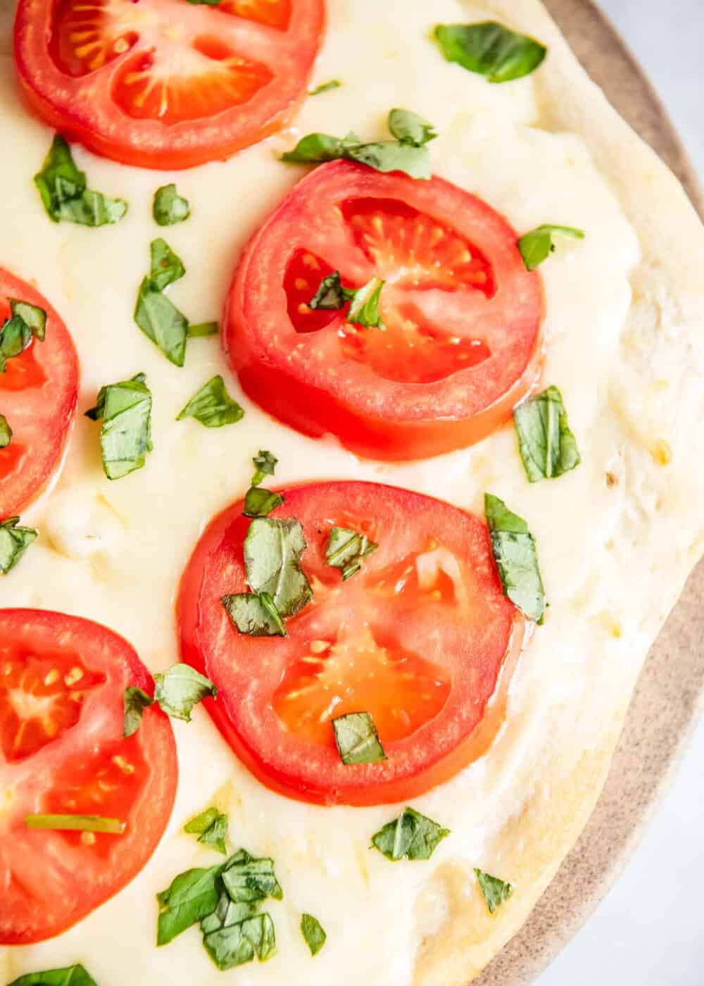 White pizza with fresh tomatoes and basil.