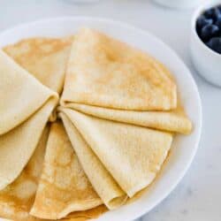 folded crepes on a white plate