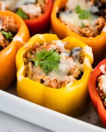 chicken stuffed peppers in a baking dish