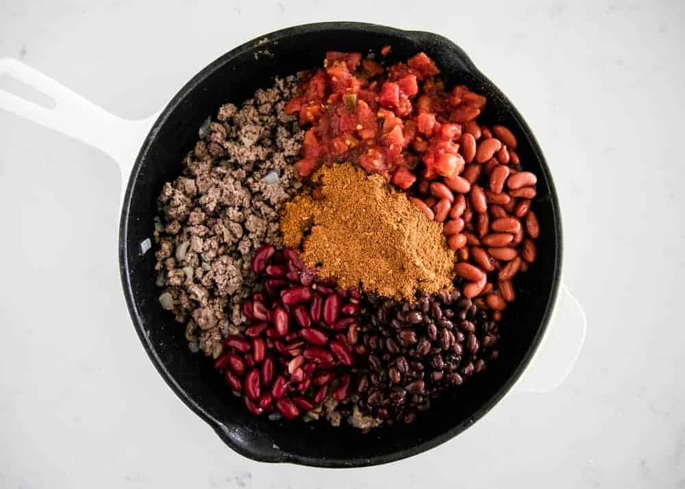 chili ingredients in a cast iron pan 