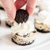 adding a mini oreo on top of a mini oreo cheesecake