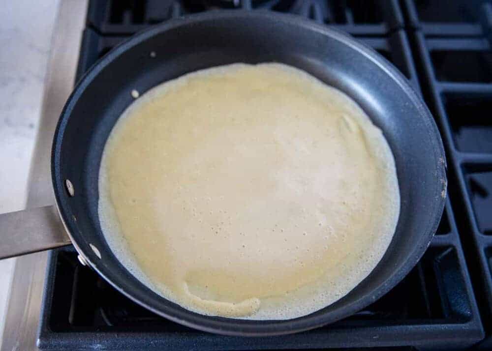 cooking a crepe on a frying pan 