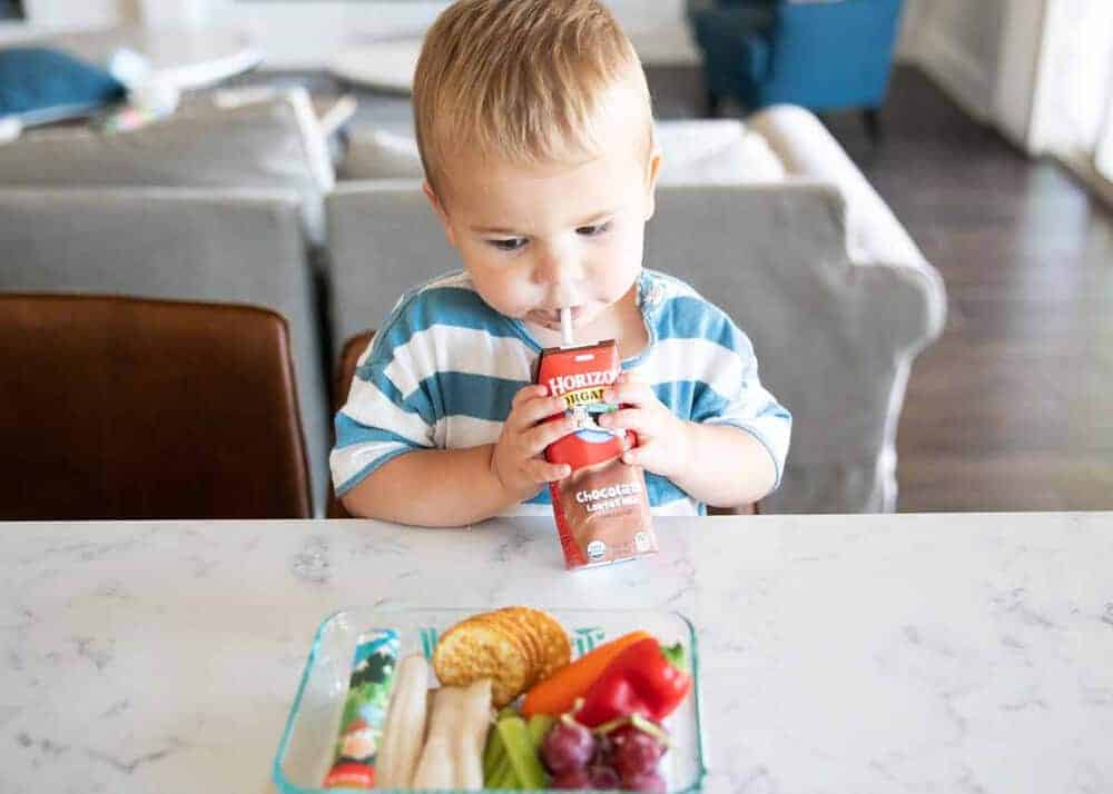 toddler drinking a chocolate milk box