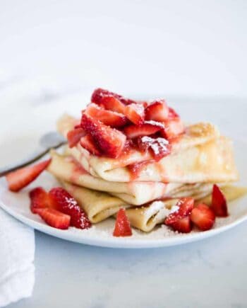 strawberry crepes on a white plate