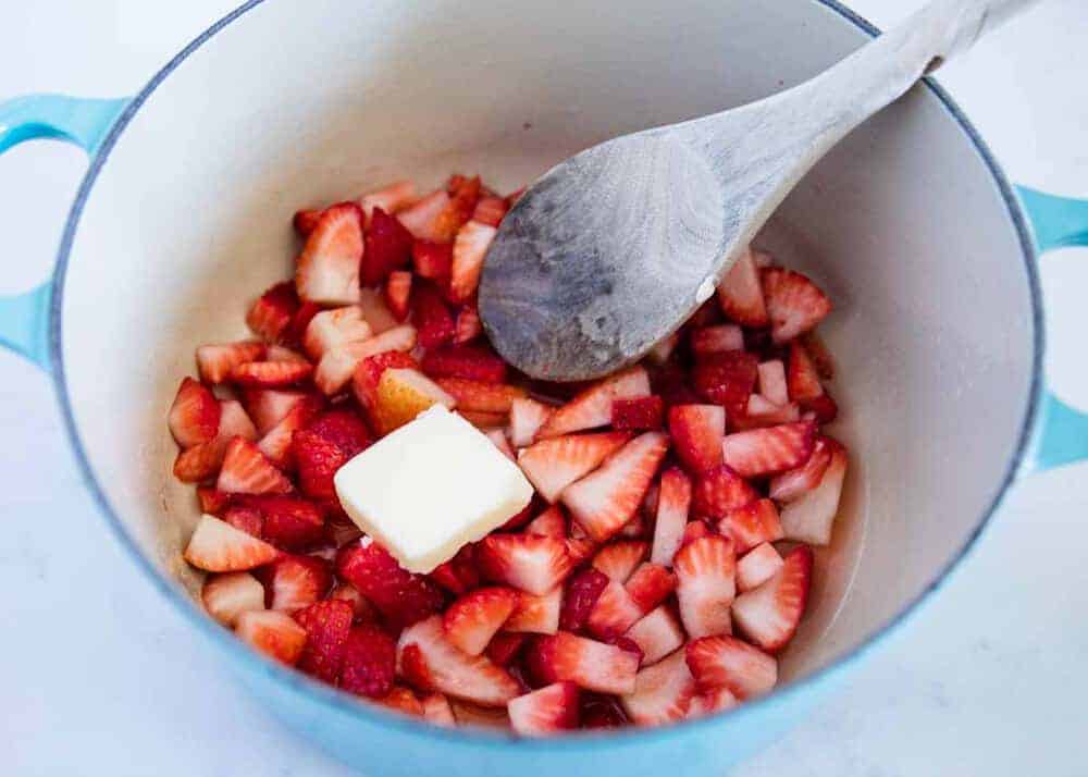 Making strawberry filling in pot.