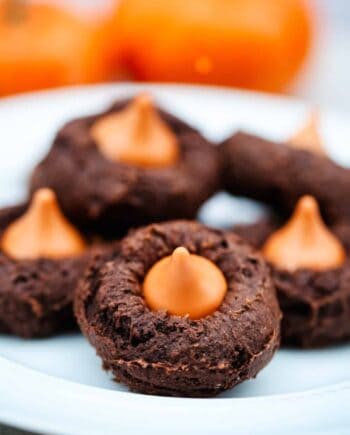 pumpkin chocolate cake mix cookies with a pumpkin Hershey kiss in the middle