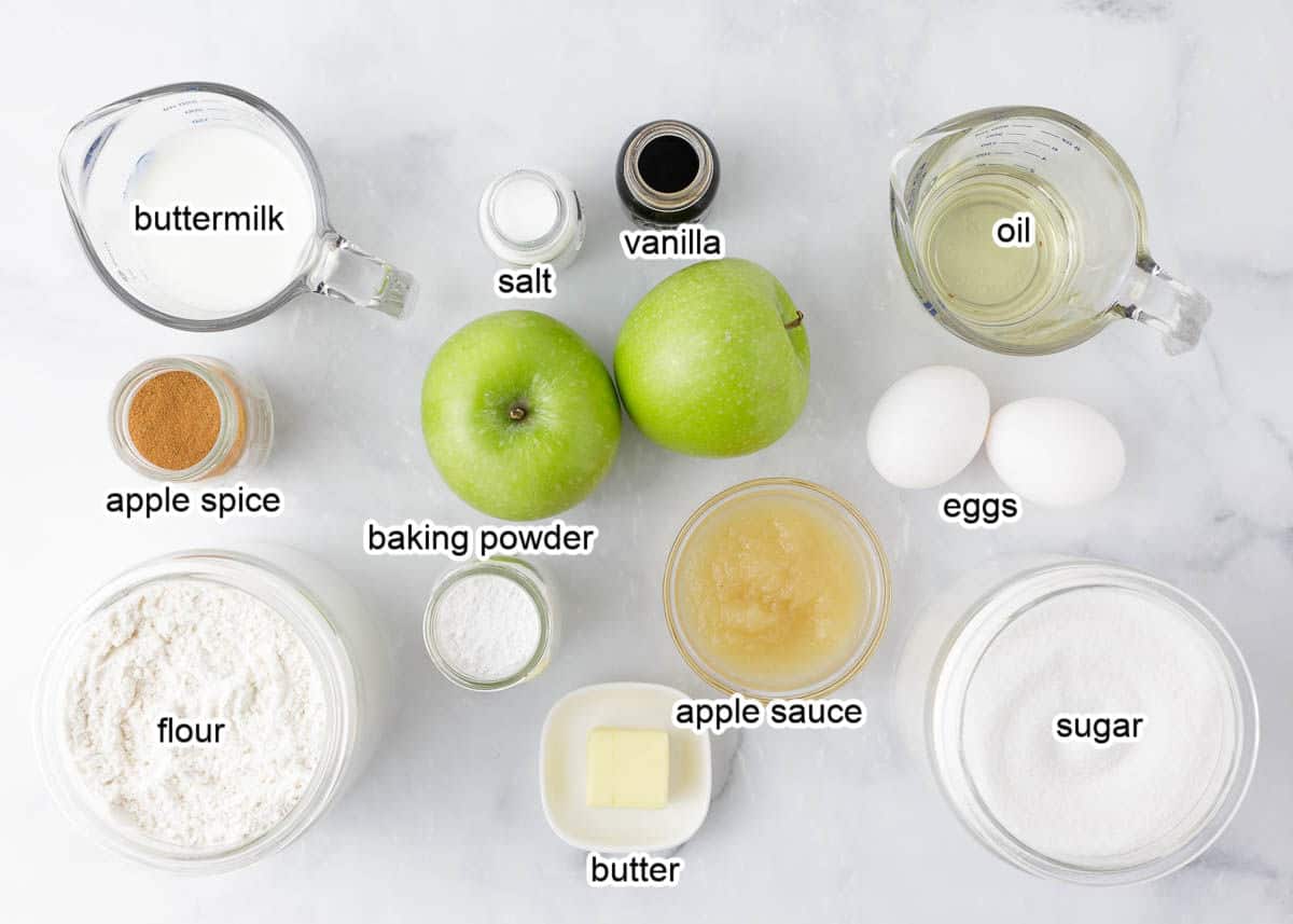 Apple muffin ingredients on a marble counter.