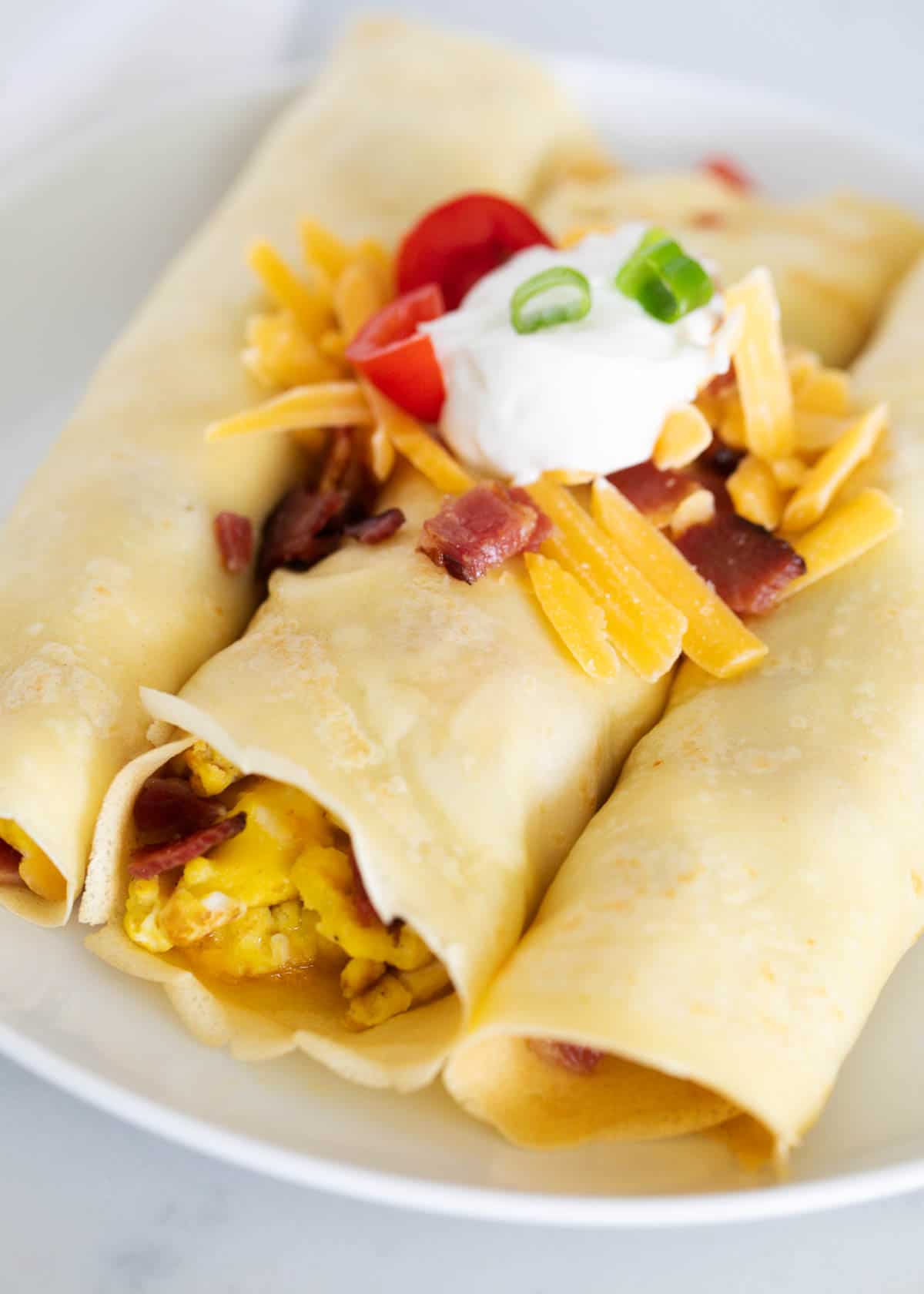 Savory crepes with eggs on a white plate.