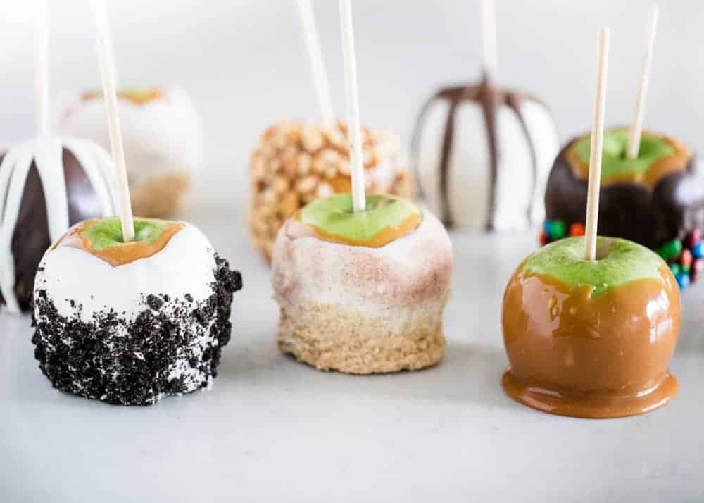 Caramel apples with chocolate and toppings.