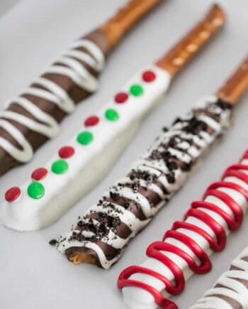 chocolate covered pretzel rods with toppings