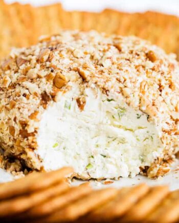 a close up of a cheese ball with crackers