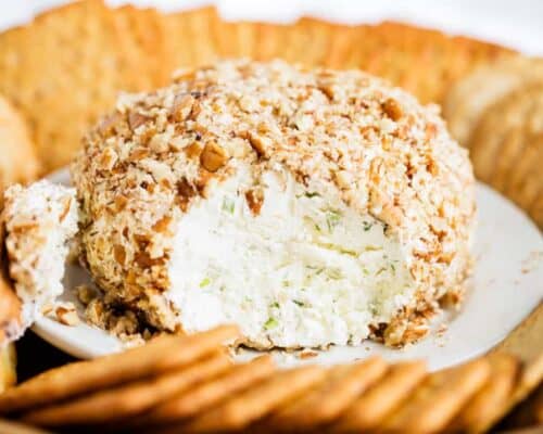 a close up of a cheese ball with crackers