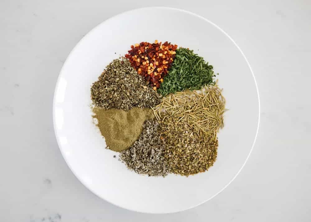 Italian seasonings on a white plate.