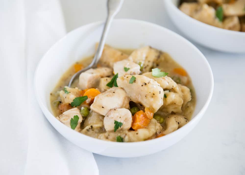 chicken and dumplings in white bowl