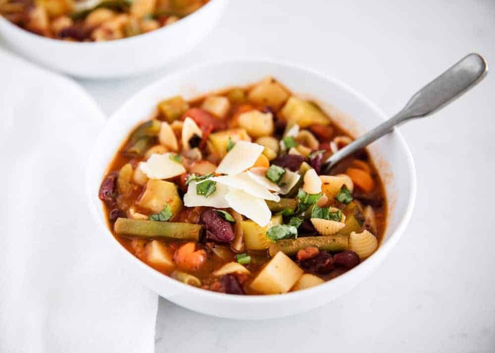 Minestrone soup in a white bowl.